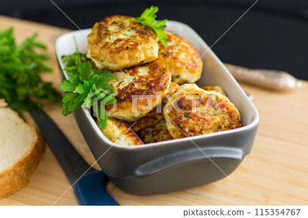 fried meat cutlets in a ceramic form on a wooden table fried meat cutlets in a ceramic form on a wooden table 115354767