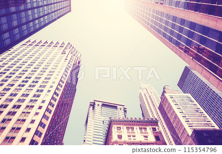 Looking up at New York City skyscrapers against the sun, color toning applied, USA. 115354796