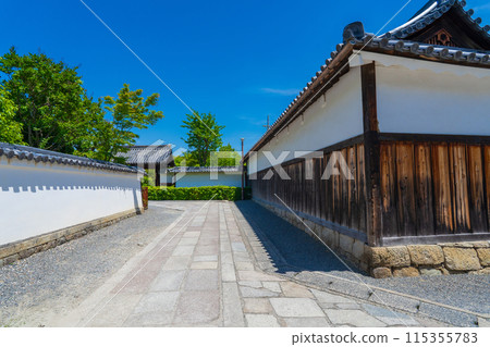 The stone-paved road and white wall of Myoshinji temple on a clear day The stone-paved road and white wall of Myoshinji temple on a clear day 115355783