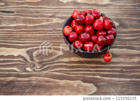 ripe cherries on blue wooden background, copy space 115356135