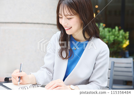A woman looking at her schedule in a cafe during work A woman looking at her schedule in a cafe during work 115356484
