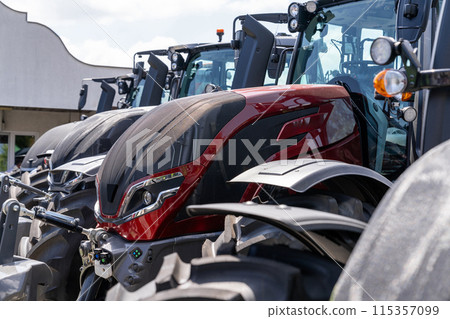 Row of agriultural tractors for sale. 115357099