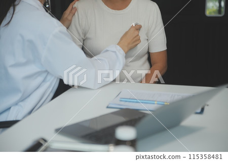 Doctor using sphygmomanometer with stethoscope checking blood pressure to a patient in the hospital. Doctor using sphygmomanometer with stethoscope checking blood pressure to a patient in the hospital. 115358481