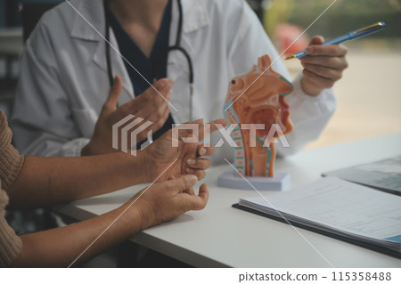 Female doctor explaining to patient results of model the process of patients. Diagnosis of diseases for Model Internal organ. Female doctor explaining to patient results of model the process of patients. Diagnosis of diseases for Model Internal organ. 115358488
