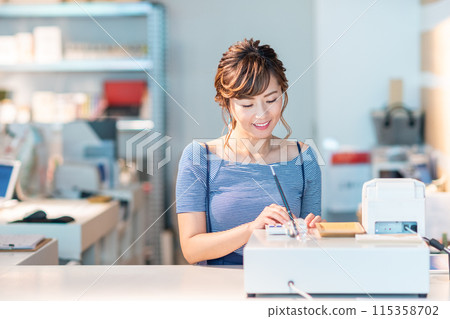 Young female shop assistant Young female shop assistant 115358702