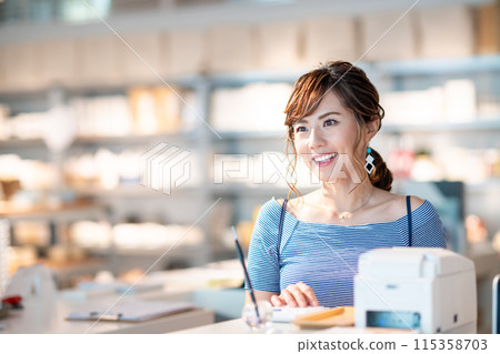 Young female shop assistant Young female shop assistant 115358703
