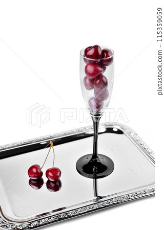 Ripe natural cherries, sweet cherries in a tall glass on a white background, selective focus 115359059
