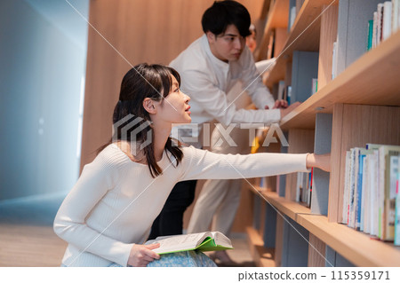 People searching for books in the library People searching for books in the library 115359171
