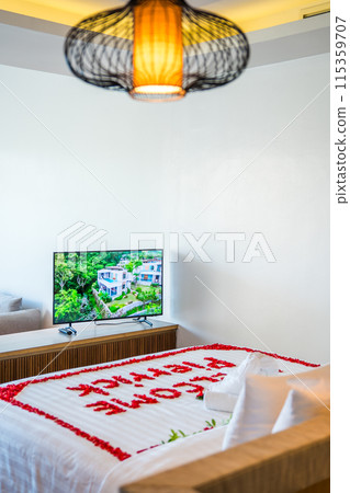 Asian girl in a hotel bed with flowers in Patong, in Phuket, Thailand 115359707