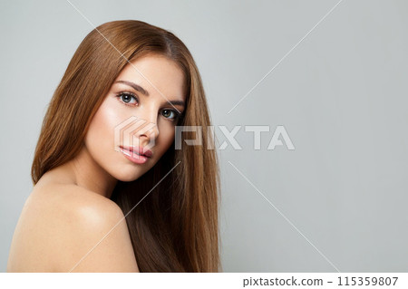 Posing woman with long hair and fresh clean skin studio portrait on grey background.  115359807