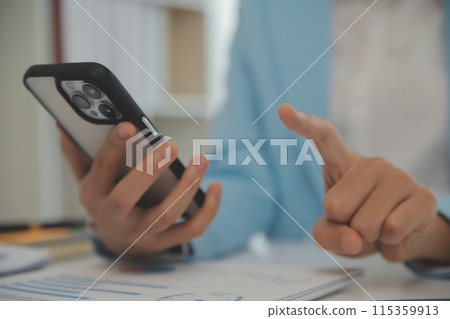 Portrait of a happy Asian businesswoman using mobile phone indoor, Asian businesswoman working in modern office. Portrait of a happy Asian businesswoman using mobile phone indoor, Asian businesswoman working in modern office. 115359913