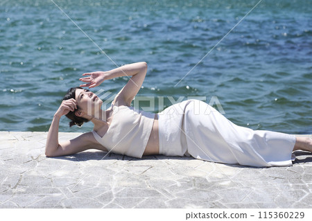 woman relaxing on the beach 115360229
