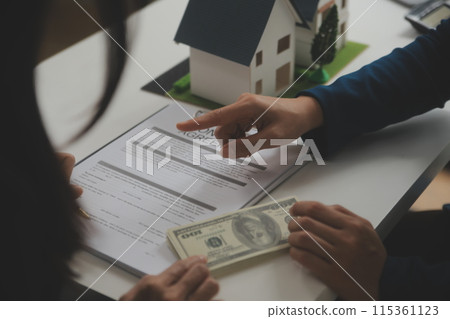 Business Signing a Contract Buy - sell house, insurance agent analyzing about home investment loan Real Estate concept. 115361123