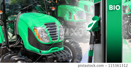 Biofuel filling station on a background of agricultural tractors. Biofuel filling station on a background of agricultural tractors. 115361312
