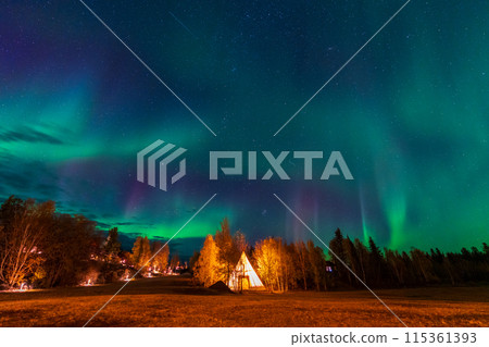 Amazing northern lights dancing over the light up Tipi or Tepees at Aurora Village in Yellowknife, Northwest Territories, Canada. 115361393