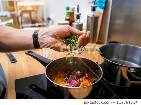 Chef at the kitchen preparing massaman curry with sweet potato and many spices 115361514