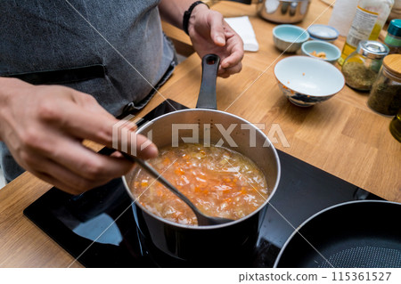 Chef at the kitchen preparing lentils soup with cauliflower and broccoli 115361527