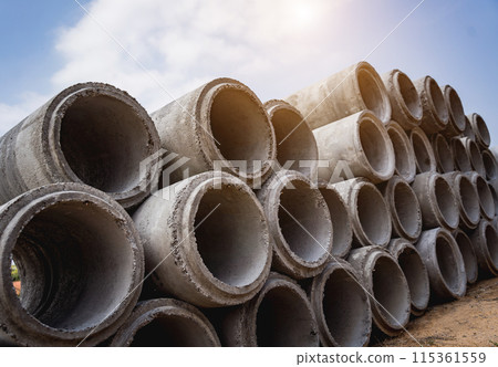 A stack of concrete ring pipes piled and creating a symmetrical arrangement A stack of concrete ring pipes piled and creating a symmetrical arrangement 115361559