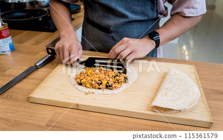 Chef at the kitchen preparing quesadillas with tofu and sweet corn 115361579