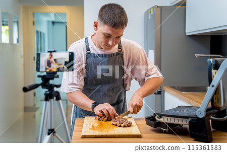The chef is broadcasting live from workshop how to prepare a beef steaks on the electric grill The chef is broadcasting live from workshop how to prepare a beef steaks on the electric grill 115361583