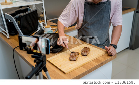 The chef is broadcasting live from workshop how to prepare a beef steaks on the electric grill 115361593