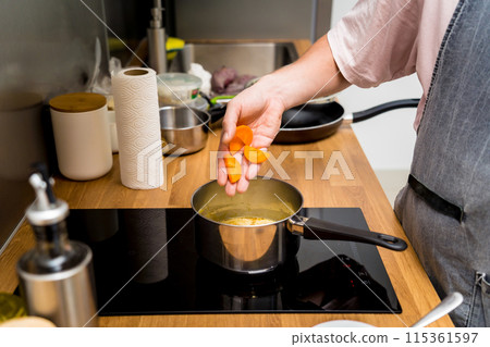 Chef at the kitchen preparing green curry with herbs and rice 115361597