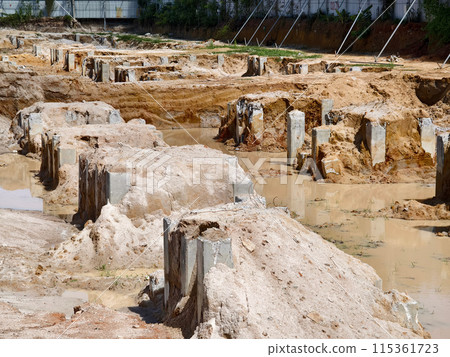 Many piles in the middle of a construction site Many piles in the middle of a construction site 115361723