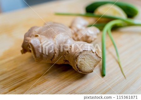 Cutting board with ingredients for preparing rice porridge with onion and sesame seeds 115361871