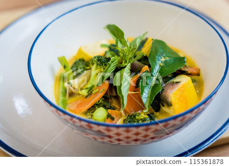 Traditional vegetable green curry with herbs and steamed rice Traditional vegetable green curry with herbs and steamed rice 115361878