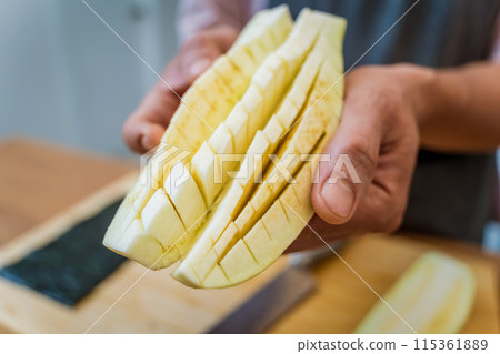 Chef at the kitchen preparing grilled eggplants with garlic 115361889
