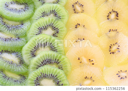 Green and gold kiwi slices, arranged in two vertical rows Green and gold kiwi slices, arranged in two vertical rows 115362256