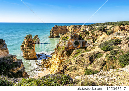 Praia da Marinha Beach among rock islets and cliffs seen from Seven Hanging Valleys Trail, Algarve, Portugal Praia da Marinha Beach among rock islets and cliffs seen from Seven Hanging Valleys Trail, Algarve, Portugal 115362547