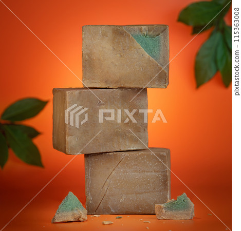 Stacked natural soap bars on orange background 115363008