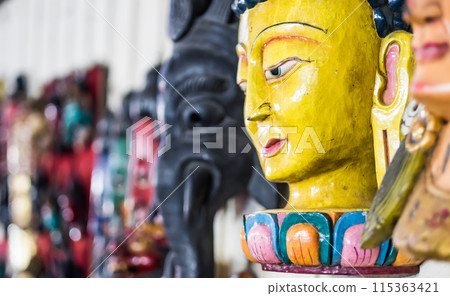 Head of buddha in the souvenir shop Head of buddha in the souvenir shop 115363421