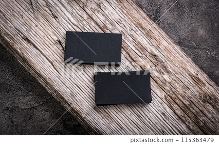 Stacks of black blank business cards on wooden background 115363479