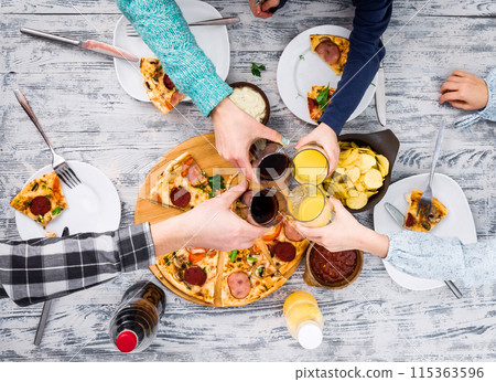 people clanging glasses together having pizza people clanging glasses together having pizza 115363596