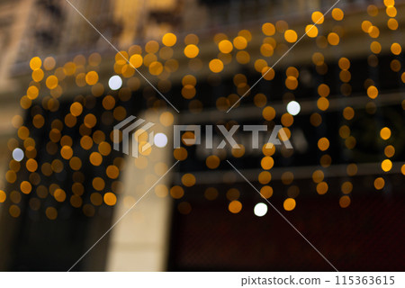 Decorative outdoor string lights at night time, Defocused Background, night city life backdrop, party time with Yellow bokeh balls 115363615