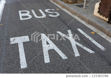 Bus and taxi lane in city. Large White Sign Shared Bus and taxi lane at Street. Bus and taxi lane in city. Large White Sign Shared Bus and taxi lane at Street. 115363706