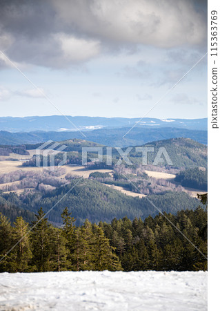 Mountains - top of the hill with snow on foreground and clouds on background, Lipno nad Vltavou, Czechia, Europe 115363769