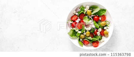 Fresh healthy vegetable Mediterranean salad of feta cheese, tomato, olives, green pepper and green basil leaves, banner,  top view 115363798