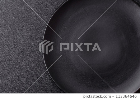 Empty ceramic round plate on dark textured concrete background 115364646