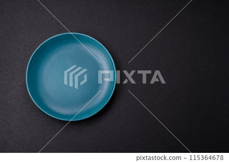 Empty ceramic round plate on dark textured concrete background Empty ceramic round plate on dark textured concrete background 115364678