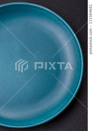 Empty ceramic round plate on dark textured concrete background Empty ceramic round plate on dark textured concrete background 115364681