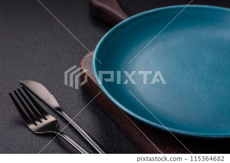 Empty ceramic round plate on dark textured concrete background 115364682
