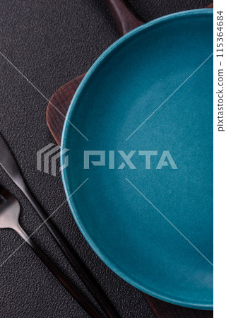 Empty ceramic round plate on dark textured concrete background 115364684