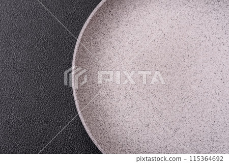 Empty ceramic round plate on dark textured concrete background 115364692