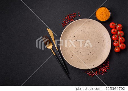 Empty ceramic round plate on dark textured concrete background 115364702