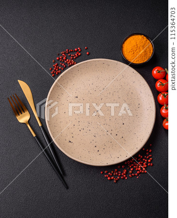 Empty ceramic round plate on dark textured concrete background 115364703
