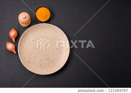 Empty ceramic round plate on dark textured concrete background 115364707