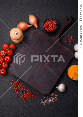 Empty wooden cutting board with spices, salt and herbs Empty wooden cutting board with spices, salt and herbs 115364750